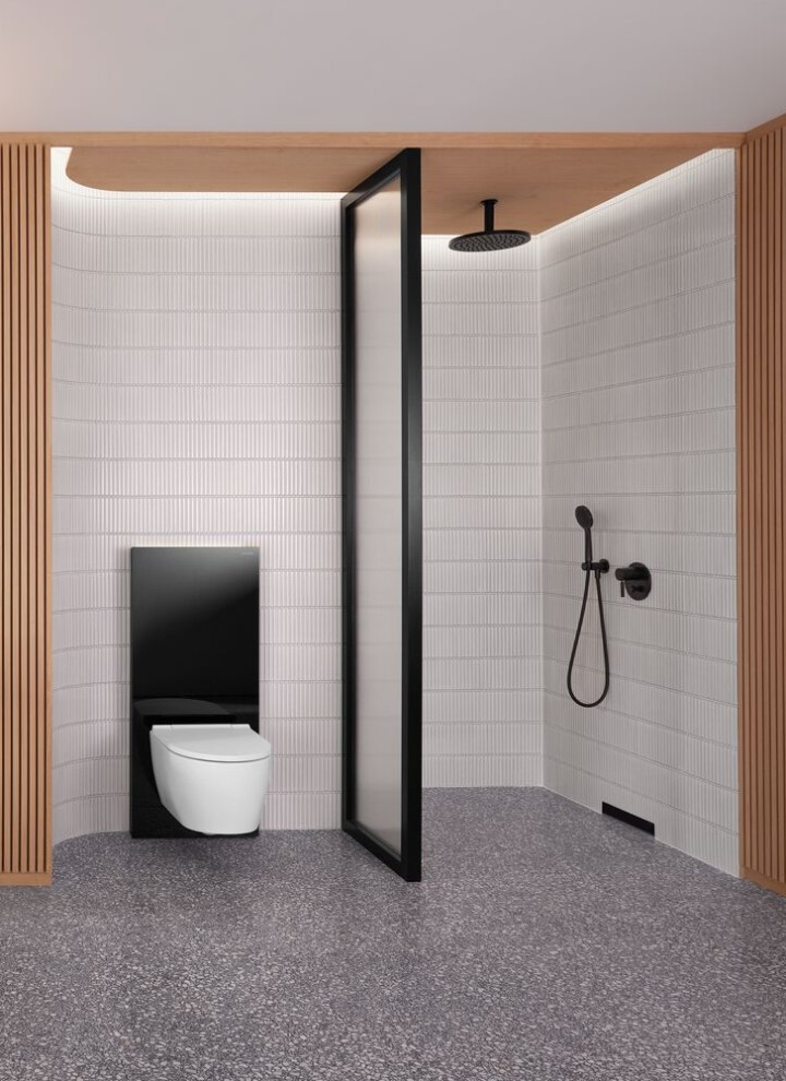 A bathroom with a wooden wall and a shower and WC area in black and white A bathroom with a wooden wall and a shower and WC area in black and white